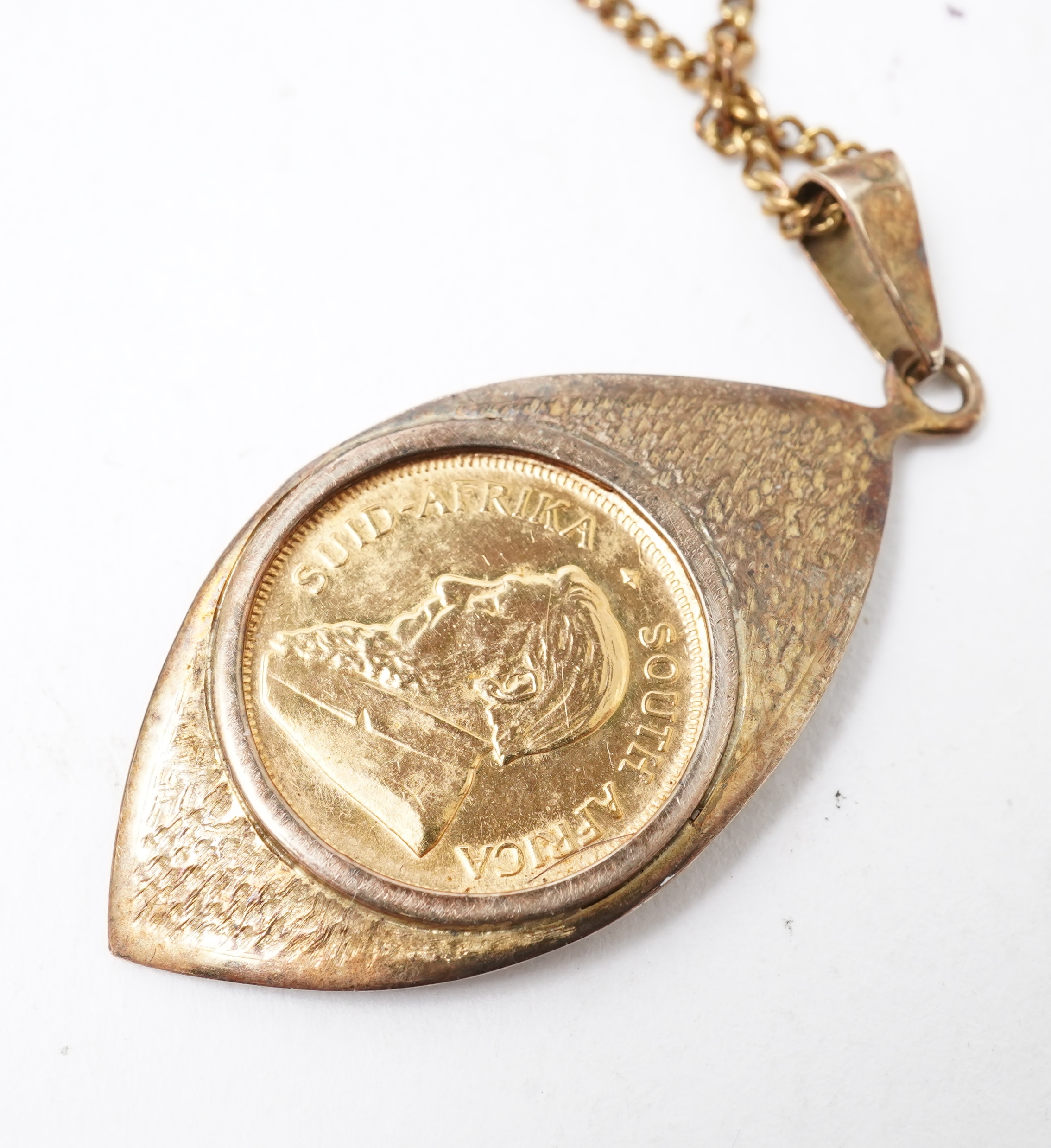 A gold 1/10 Krugerrand coin necklace, circa 1988 and later